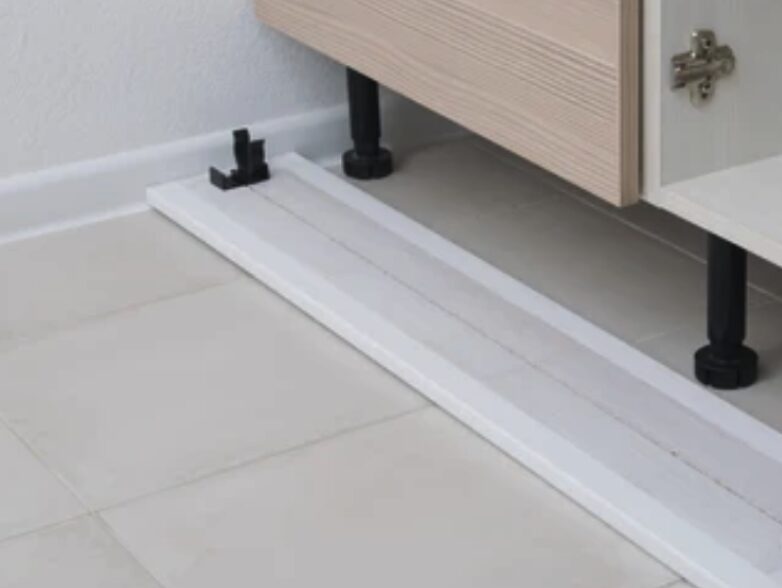 Adjustable cabinet legs with a snap-on toe kick installed at the base of a DodiHome cabinet