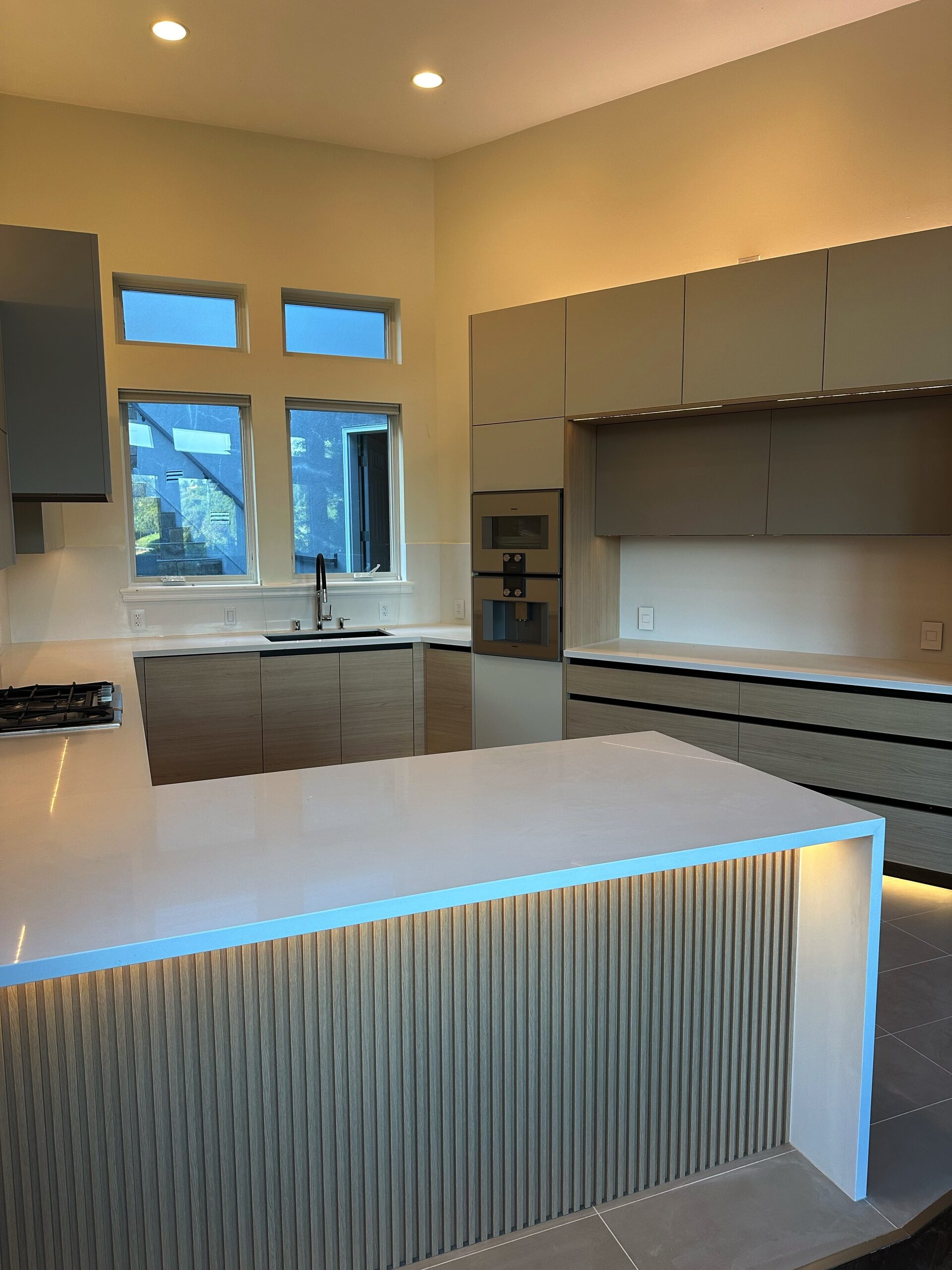 Primary finished-room view of modern kitchen with fluted island cabinetry and surrounding surfaces