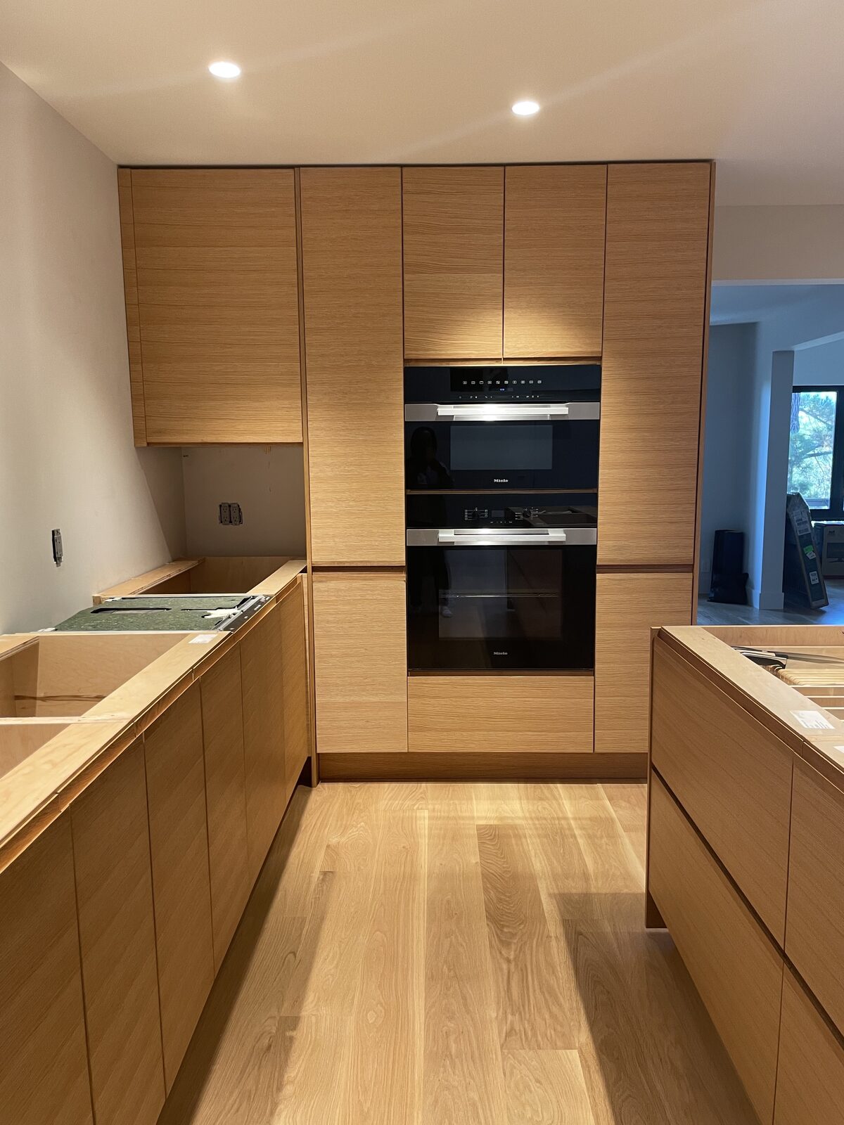 Primary finished-room view of white oak pantry cabinetry and surrounding surfaces