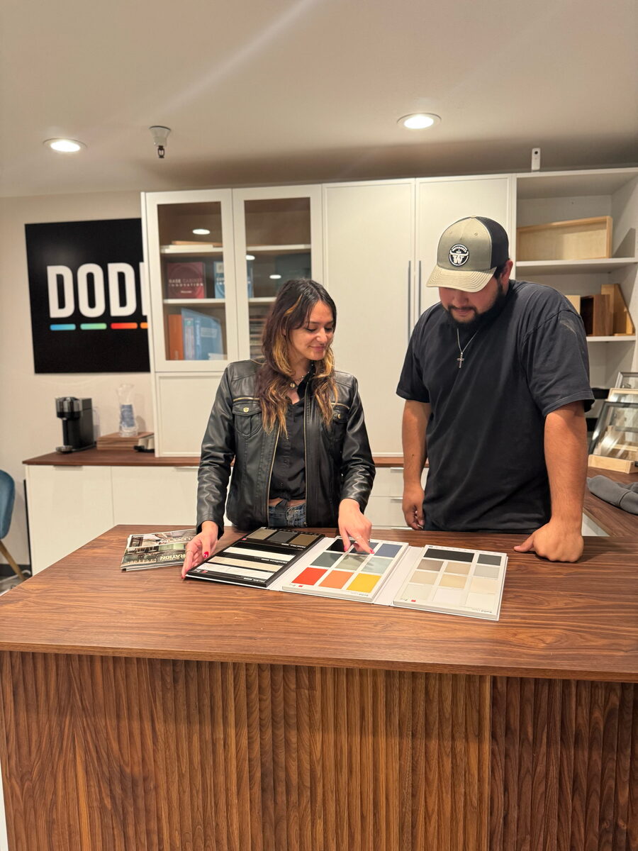 DodiHome team member with a customer at the showroom counter, reviewing finish samples — Milpitas, CA
